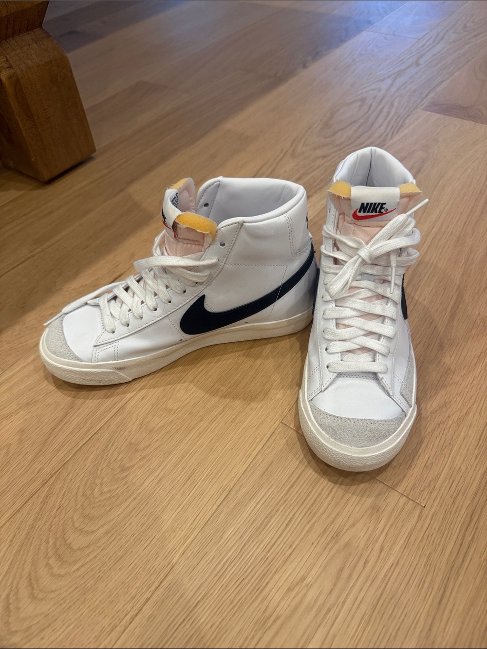 Nike High-Top Sneakers in White with Black Swoosh and Yellow Tongue Detail